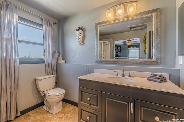 bathroom featuring vanity, toilet, plenty of natural light, and tile patterned flooring