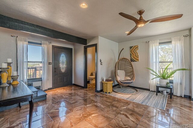 entrance foyer featuring plenty of natural light and ceiling fan