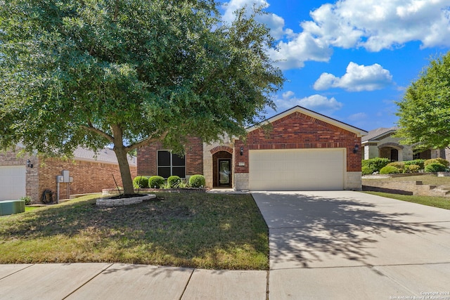 view of front of home with a garage and central AC