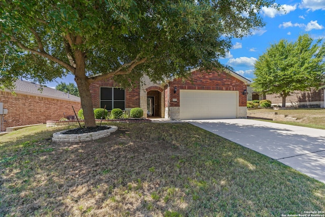 view of front of property with a garage and a front lawn