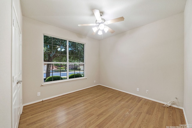 spare room with light wood-type flooring and ceiling fan