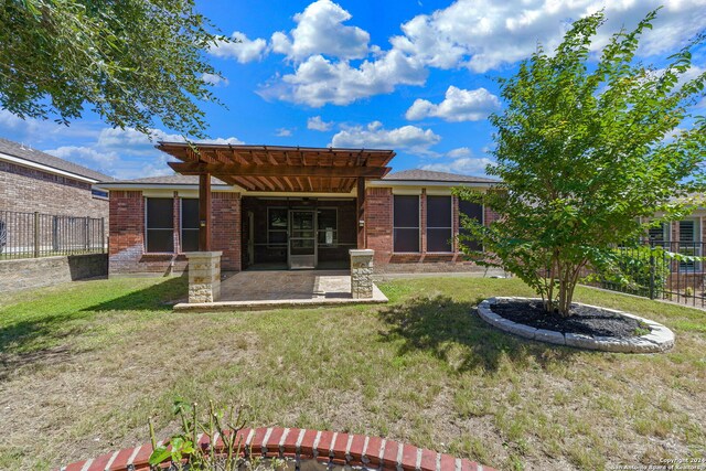 back of property featuring a patio area and a lawn