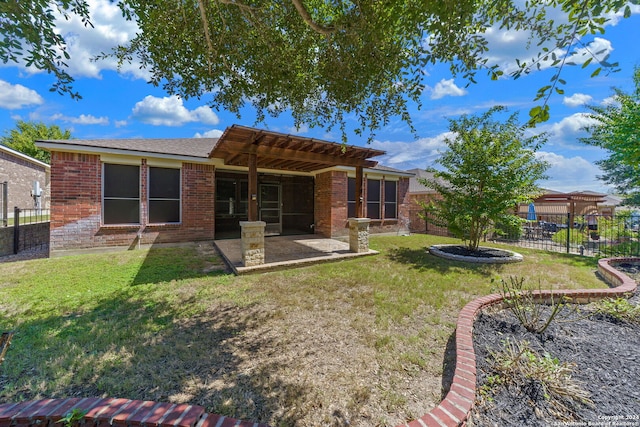 back of property with a patio area and a lawn