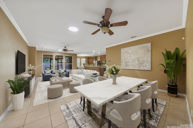 tiled dining space with ornamental molding and ceiling fan