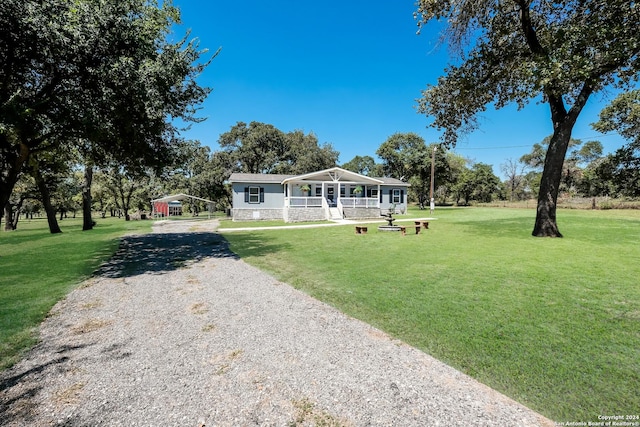 1350 Blue Quail Dr, Lytle, TX 78052 - view of front of house featuring a front lawn, a carport, and covered porch