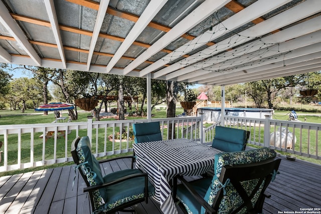 wooden terrace featuring a lawn