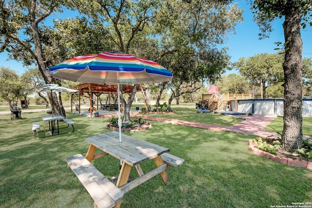1350 Blue Quail Dr, Lytle, TX 78052 - view of home's community with stairway, a pool, a yard, a gazebo, and a deck