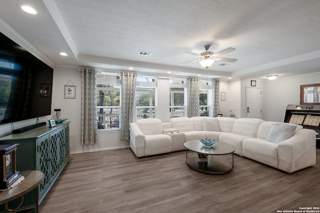 living room with a textured ceiling, wood-type flooring, and ceiling fan