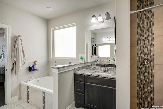 bathroom featuring vanity, a healthy amount of sunlight, independent shower and bath, and tile patterned flooring