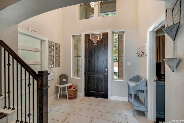 entryway with light tile patterned floors and a wealth of natural light