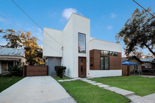 view of front of property with a front yard and a garage