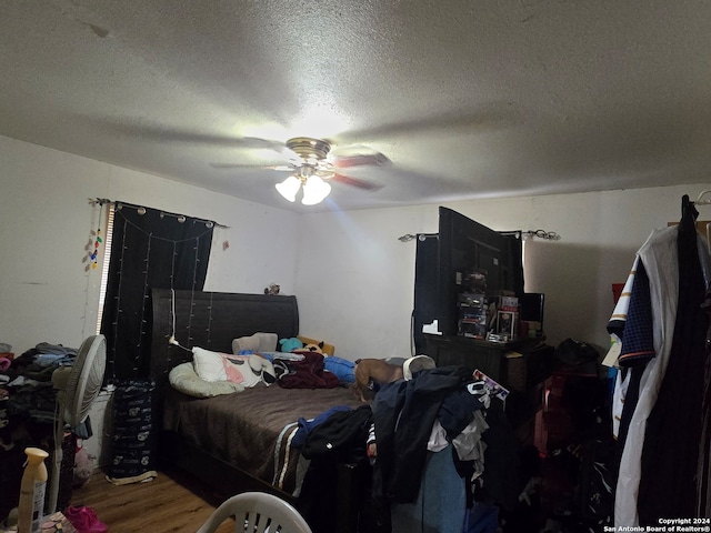 bedroom featuring a textured ceiling, ceiling fan, and wood-type flooring