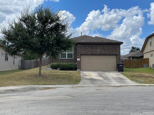 view of front of house featuring a garage and a front lawn