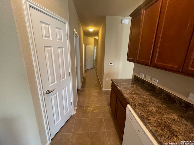 kitchen with dishwasher and dark tile patterned floors