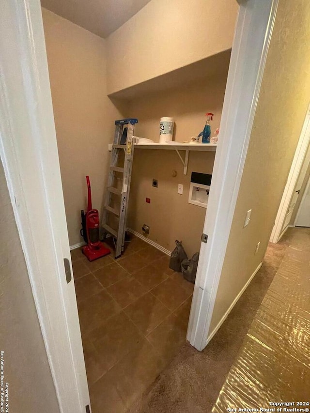 laundry area with washer hookup, dark tile patterned flooring, and electric dryer hookup