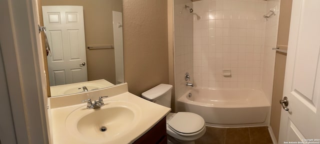 full bathroom featuring tiled shower / bath, vanity, toilet, and tile patterned floors