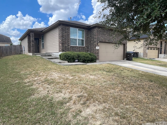 view of front of house with a garage and a front lawn