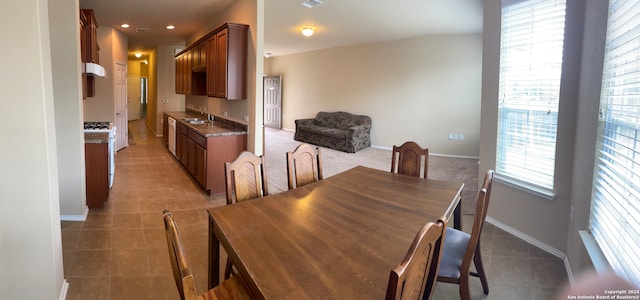 dining area with light tile patterned flooring and sink