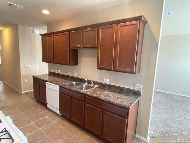 kitchen with light colored carpet, white dishwasher, and sink