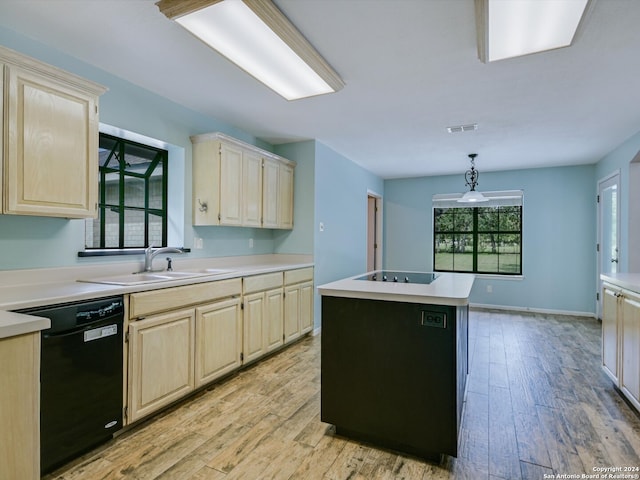 kitchen with a kitchen island, black appliances, light hardwood / wood-style floors, hanging light fixtures, and sink