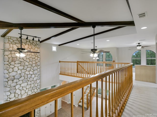 hall featuring beam ceiling and light carpet