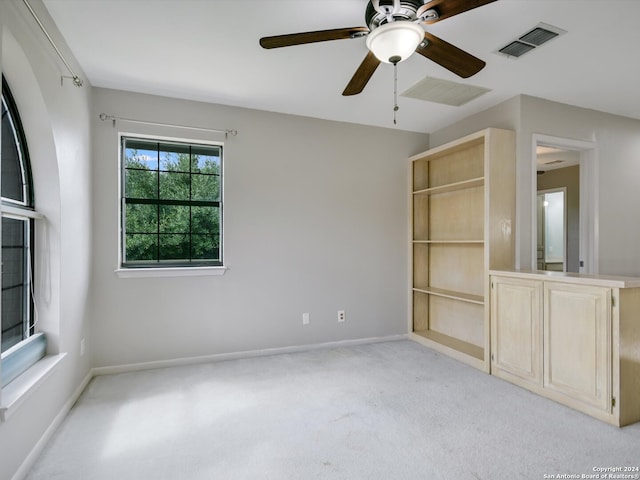 unfurnished room featuring ceiling fan and light carpet