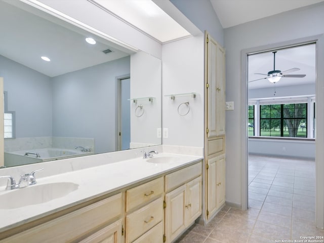 bathroom with vanity, ceiling fan, a bathtub, and tile patterned floors