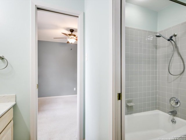 bathroom with vanity, ceiling fan, and tiled shower / bath combo