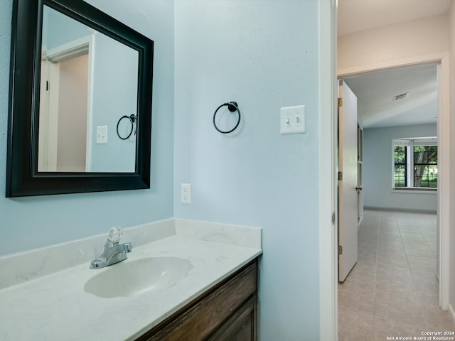 bathroom with tile patterned flooring and vanity