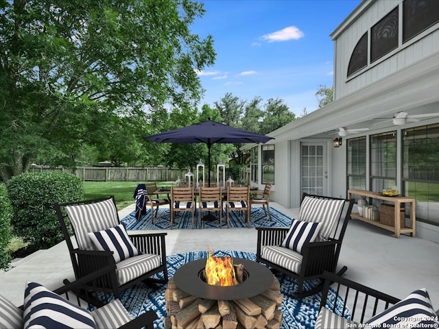 view of patio with an outdoor living space with a fire pit and ceiling fan