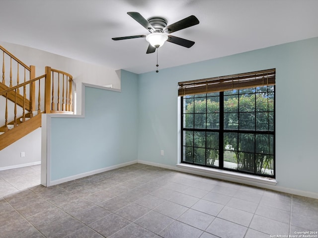 spare room with light tile patterned flooring and ceiling fan