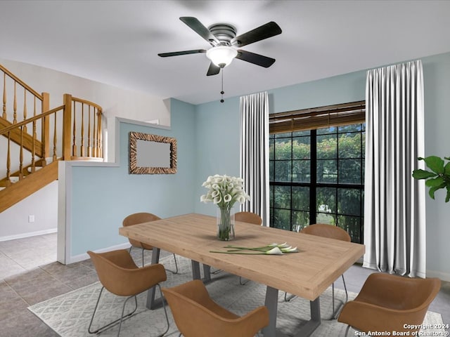 tiled dining area with ceiling fan