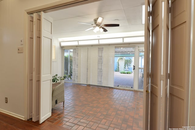 interior space with ceiling fan