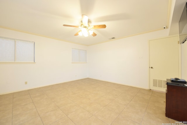 empty room with ornamental molding and ceiling fan