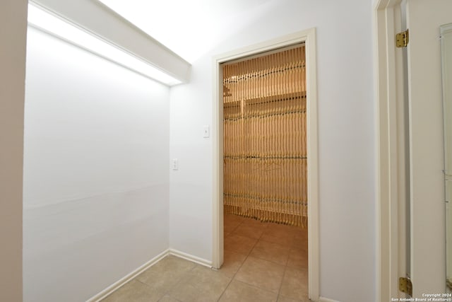 hall featuring light tile patterned flooring