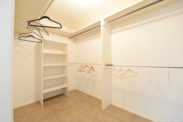 spacious closet featuring tile patterned flooring