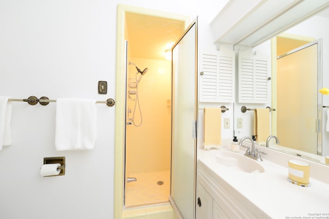 bathroom featuring vanity and a shower with shower door