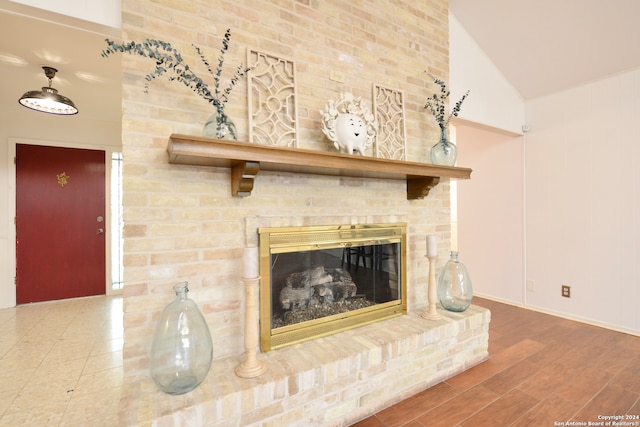 interior details with hardwood / wood-style floors and a brick fireplace