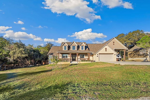 view of front of house with a garage, covered porch, and a front yard