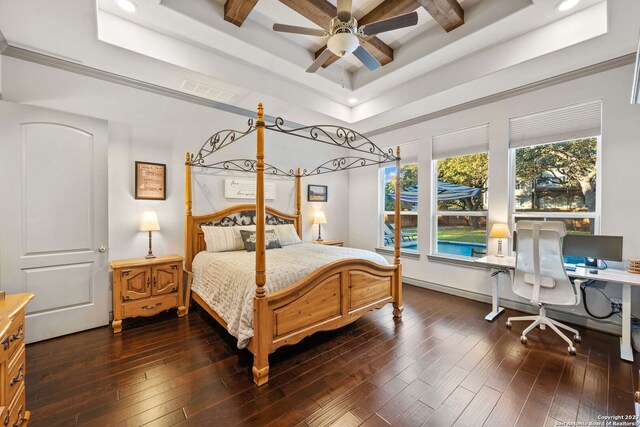 bedroom featuring ceiling fan, a raised ceiling, dark hardwood / wood-style flooring, and crown molding