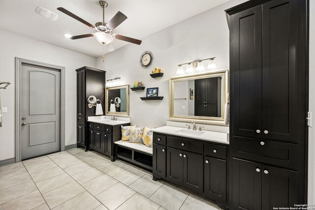 bathroom with tile patterned flooring, vanity, and ceiling fan