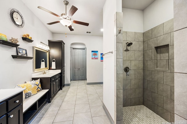 bathroom featuring vanity, tiled shower, ceiling fan, and tile patterned floors