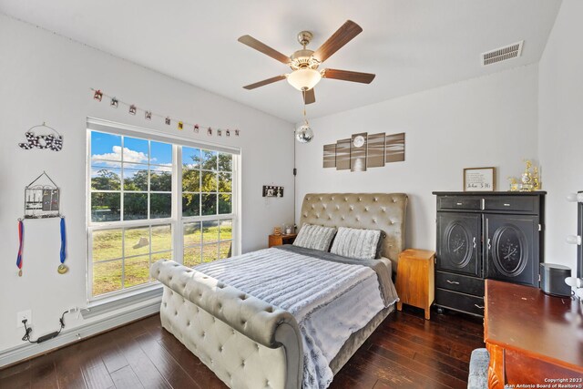 living room featuring ceiling fan and dark hardwood / wood-style floors