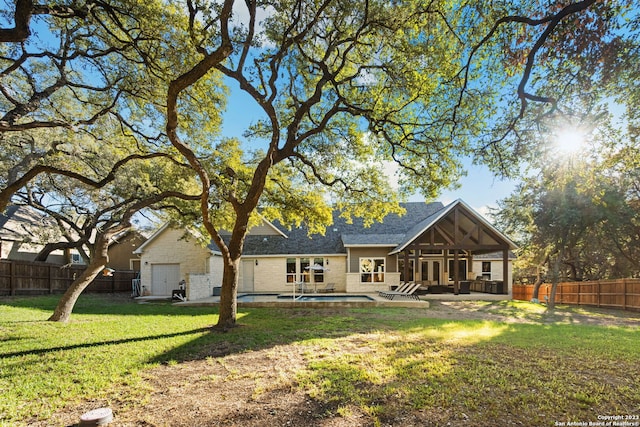 back of house with a yard