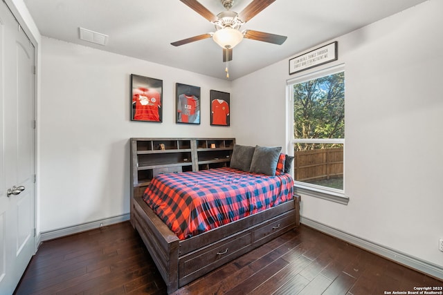 bedroom featuring dark wood-type flooring, a closet, and ceiling fan