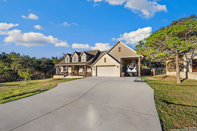 view of front facade with a garage, a front yard, and a carport