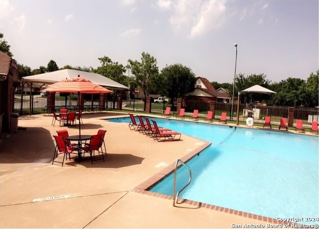 view of swimming pool with a gazebo and a patio