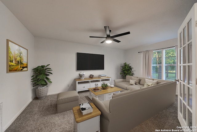 carpeted living room with ceiling fan