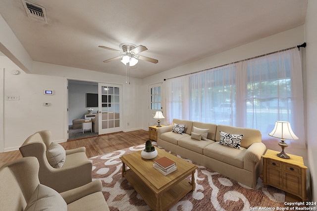 living room with wood-type flooring and ceiling fan