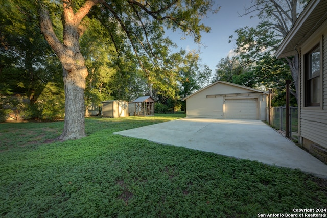 view of yard featuring a garage and a shed